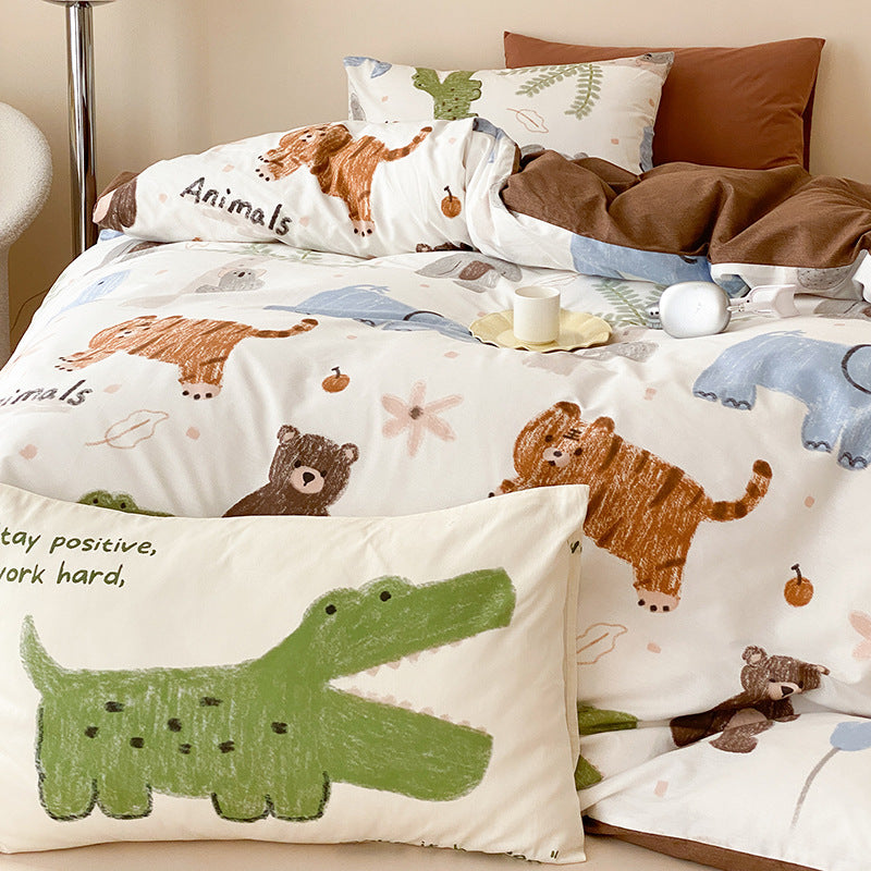 A full bedroom scene with a bed covered in a white duvet with cartoon bears, tigers, and alligators. There are also matching pillows with animal designs.