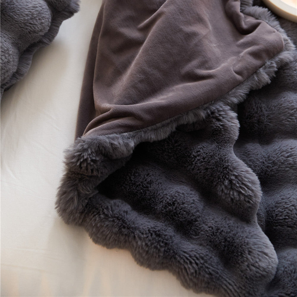 Close-up of the reversible Charcoal faux rabbit fur throw blanket, showing both fluffy and smooth sides.