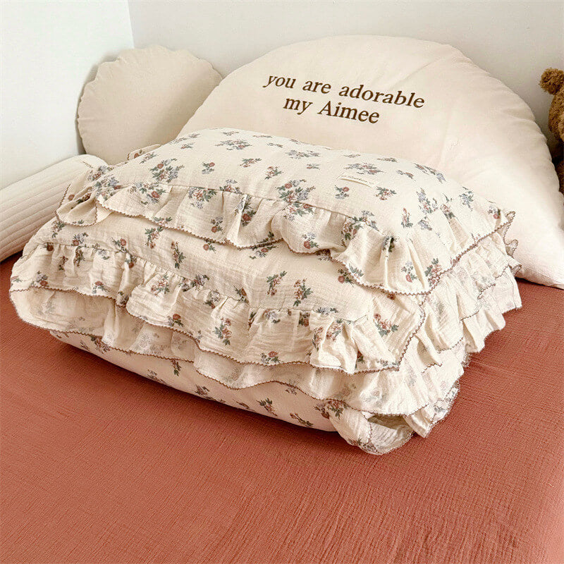 Folded floral duvet cover with frills on cream and red base