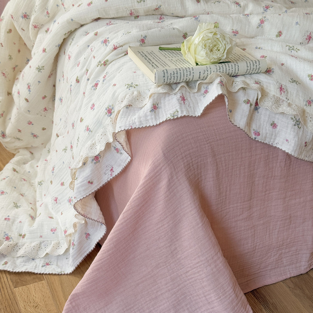 Side view of floral cotton comforter with double ruffle edges
