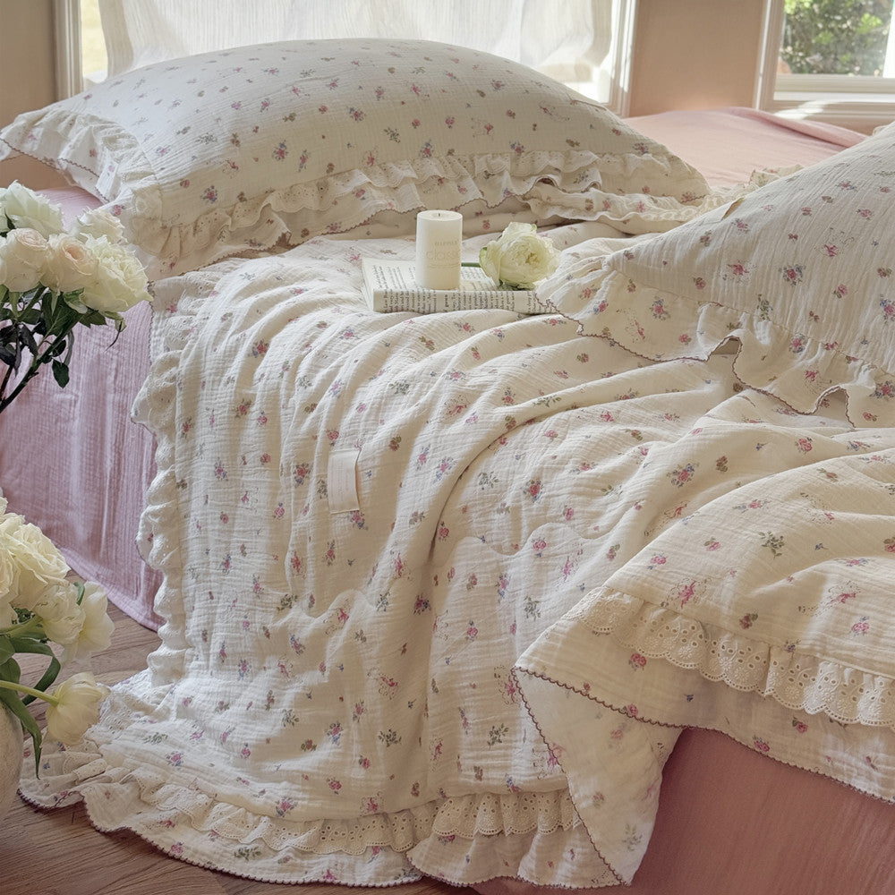Lightweight pink floral comforter with gauze sheets and cozy styling