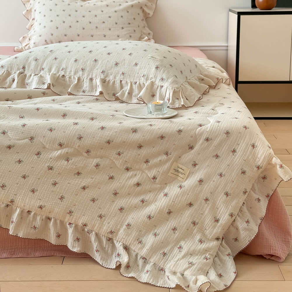 Tiny rose muslin quilt with ruffle edges and pink rosebud print
