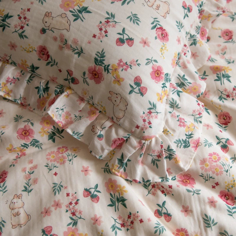 A close-up of a pillow and duvet from the pink floral bunny bedding set, highlighting the detailed print of bunnies and flowers.