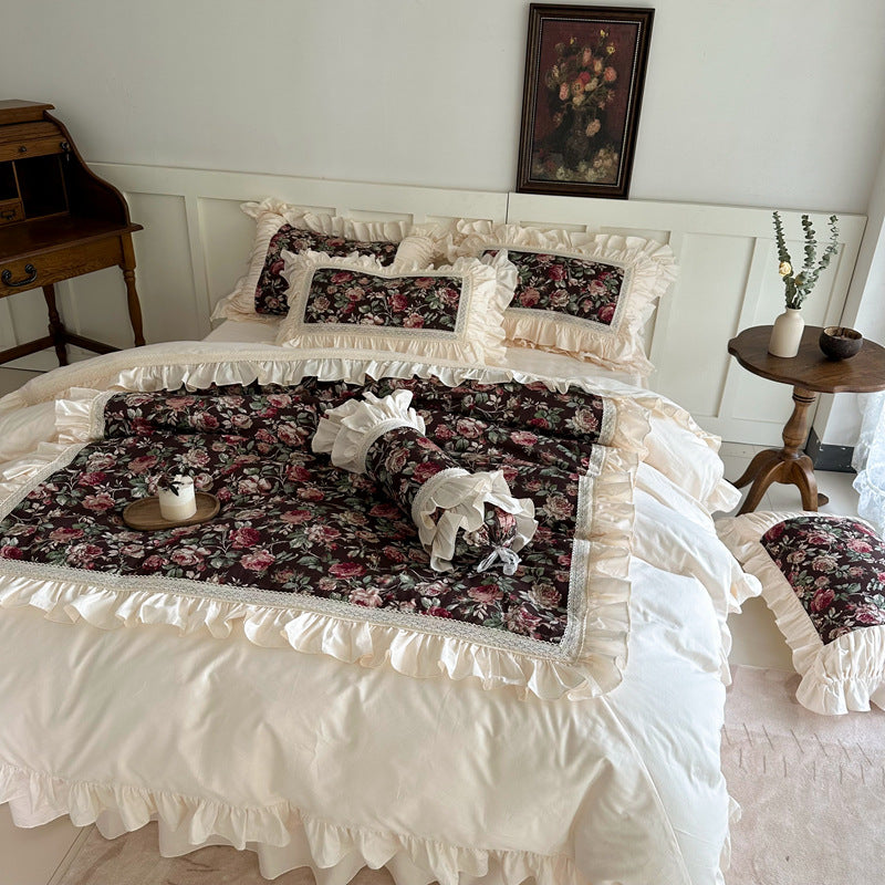 Front view of romantic dark cotton bedding with vintage roses