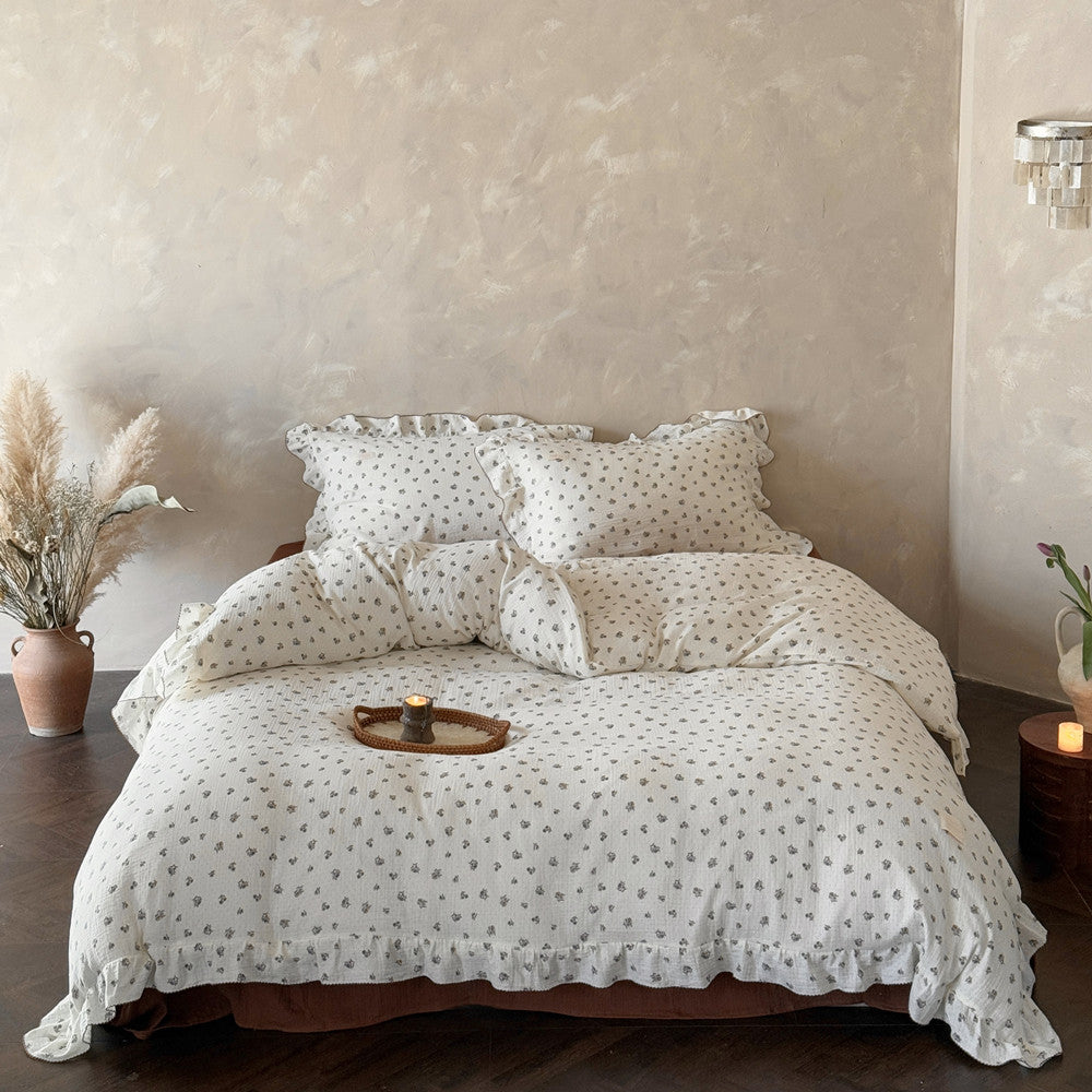 Full view of vintage floral duvet cover set with ruffled pillows and comforter