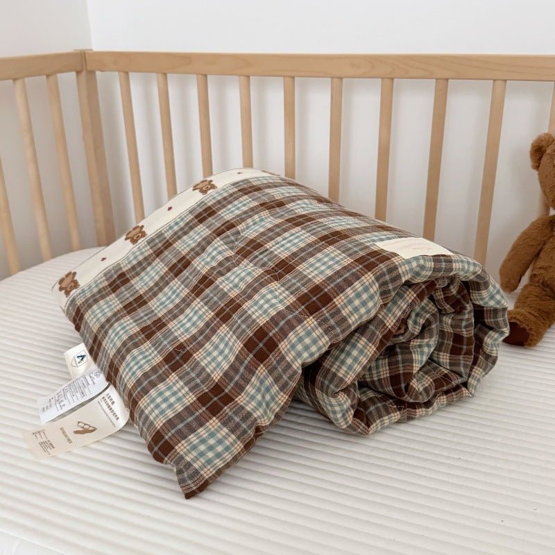 Soft cotton gauze comforter rolled to show filling and double gauze fabric