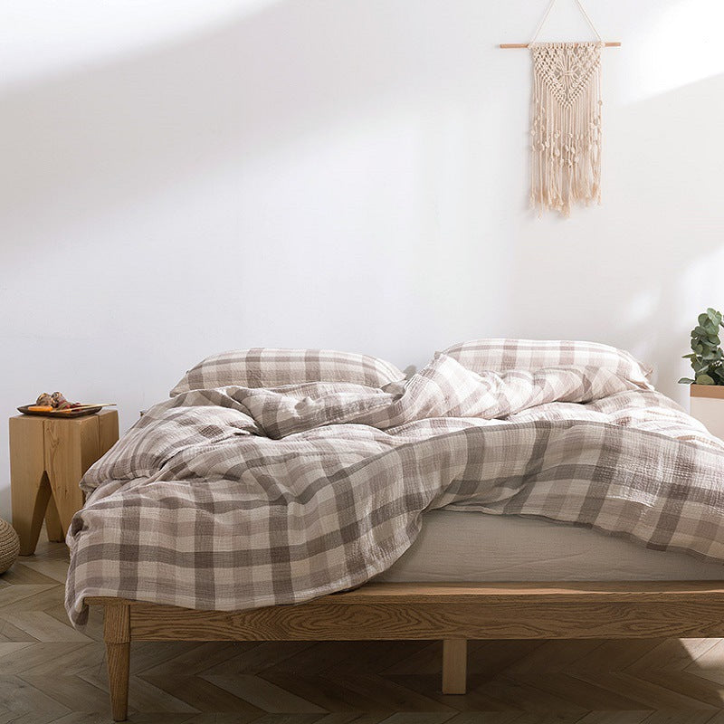 Close-up of beige plaid cotton gauze bedding – lightweight and textured surface