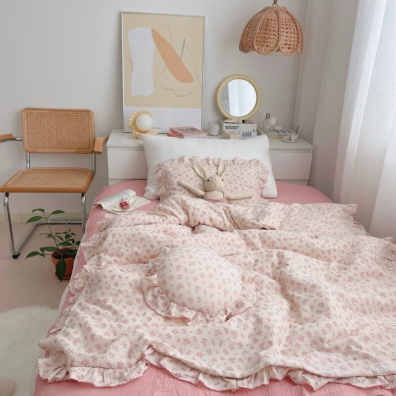 Cozy vintage-style bedding with carmine floral duvet, ruffled pillow, and dusty pink sheet