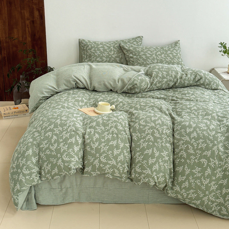 A full view of a bed dressed with the green jacquard duvet cover set, showcasing the woven leaf pattern and matching pillowcases.