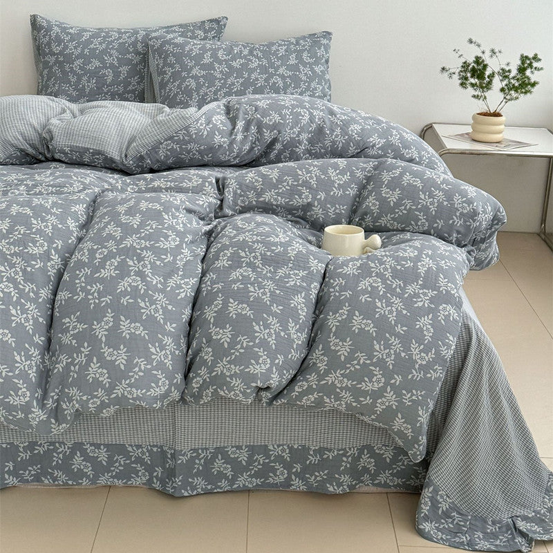A full view of a bed with the grey jacquard duvet cover set, featuring a beautiful woven leaf pattern and two matching pillows.