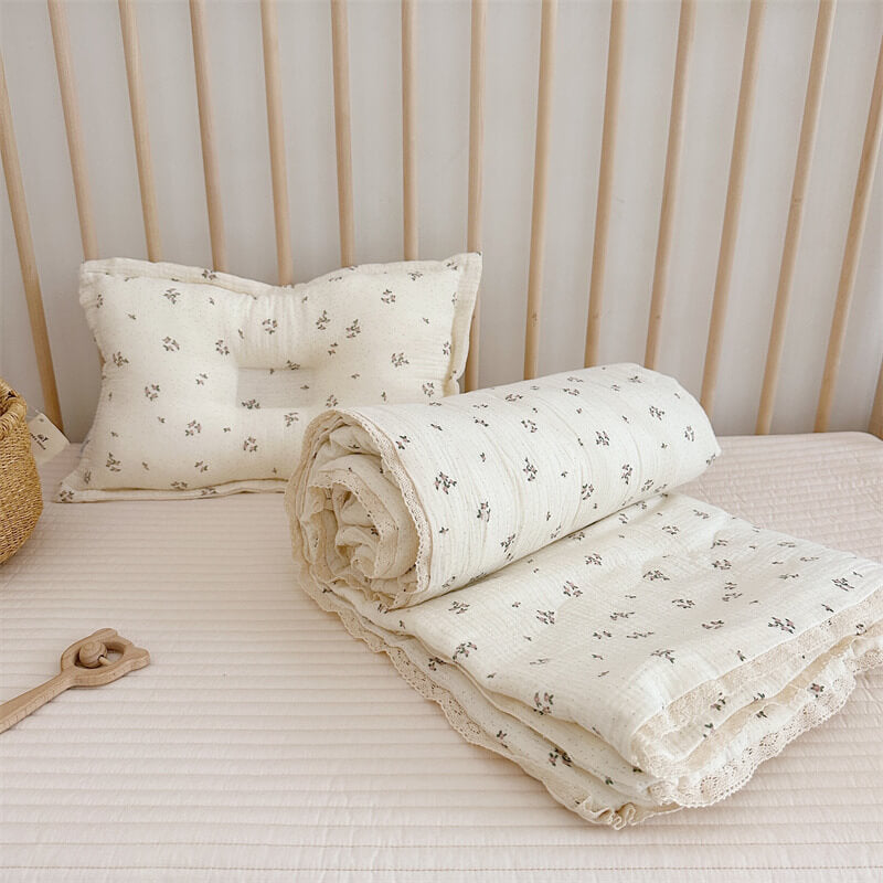 infant qult with matching pillow in crib