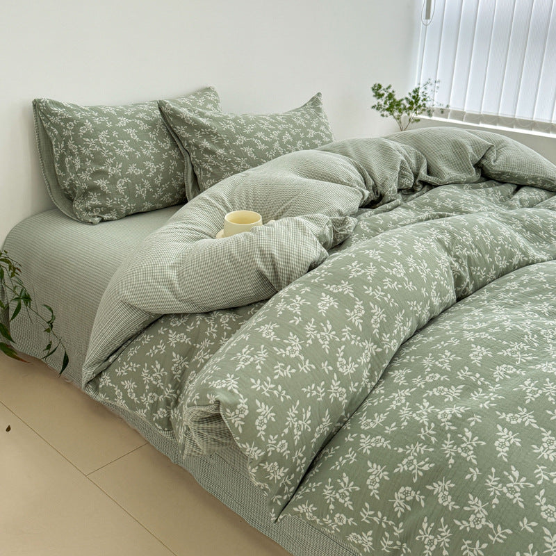 A side view of the green jacquard cotton duvet cover set, highlighting the texture and drape of the fabric on the bed.