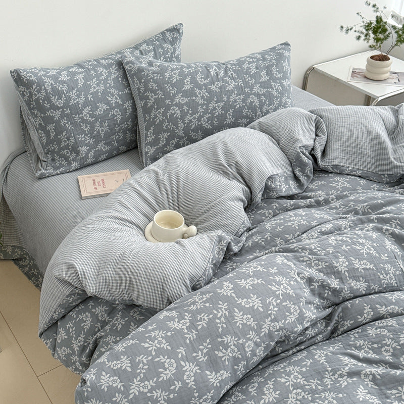 A detailed lifestyle image of the grey jacquard cotton duvet cover set, with a focus on the woven leaf pattern and the subtle texture of the material.