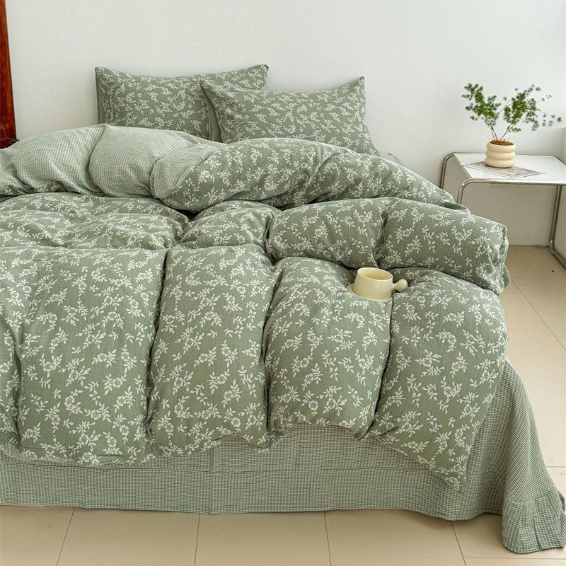 A full view of a bed with a green jacquard weave duvet cover set, showcasing the intricate woven leaf pattern and a relaxed, comfortable feel.