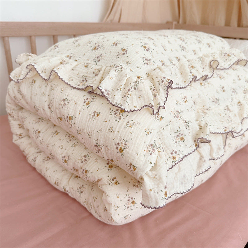 Cotton Muslin Violet Floral Ruffle Duvet Cover Set on a crib