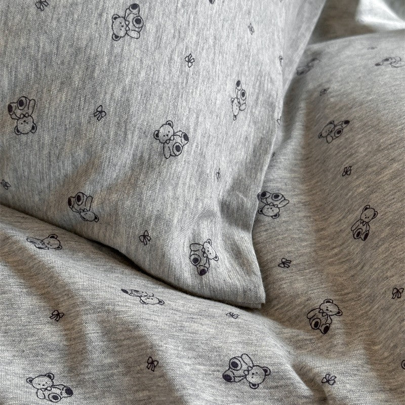Detailed fabric view of knit cotton duvet cover with grey bear print