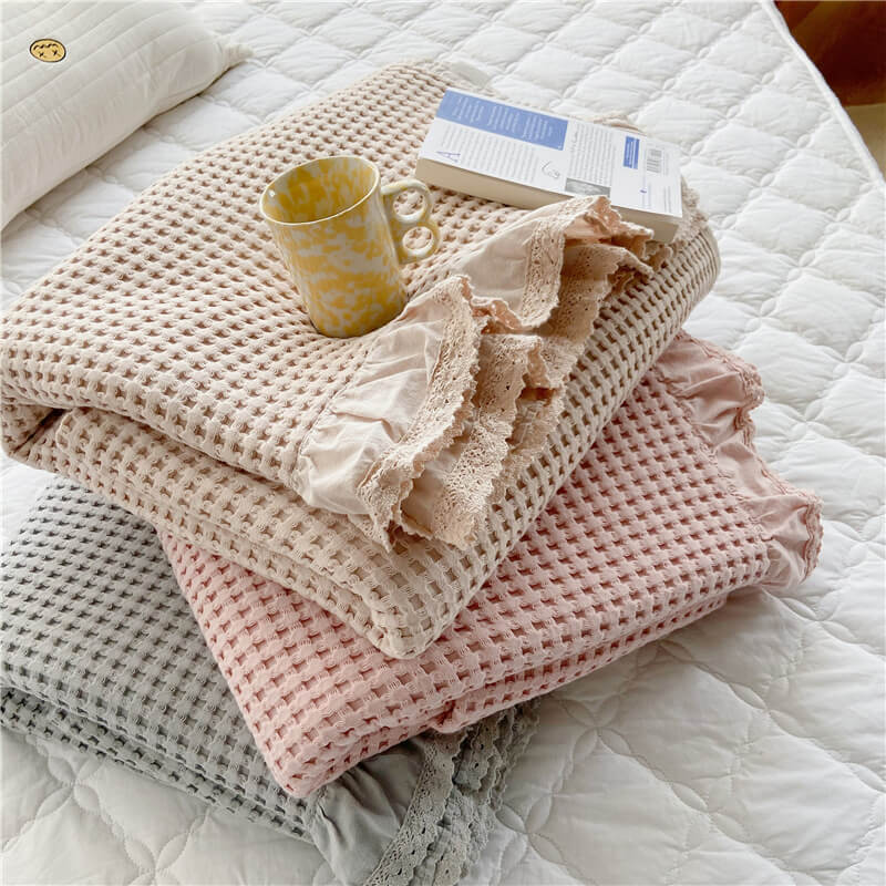 lightweight cotton waffle blanket on a bed
