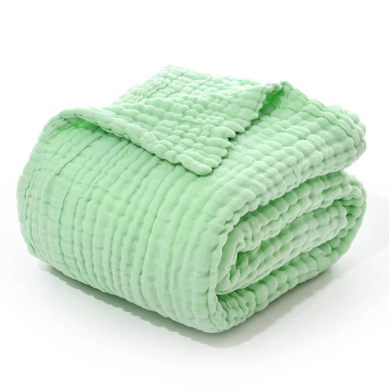 A folded 6-layer cotton muslin receiving blanket in a solid sage green color.