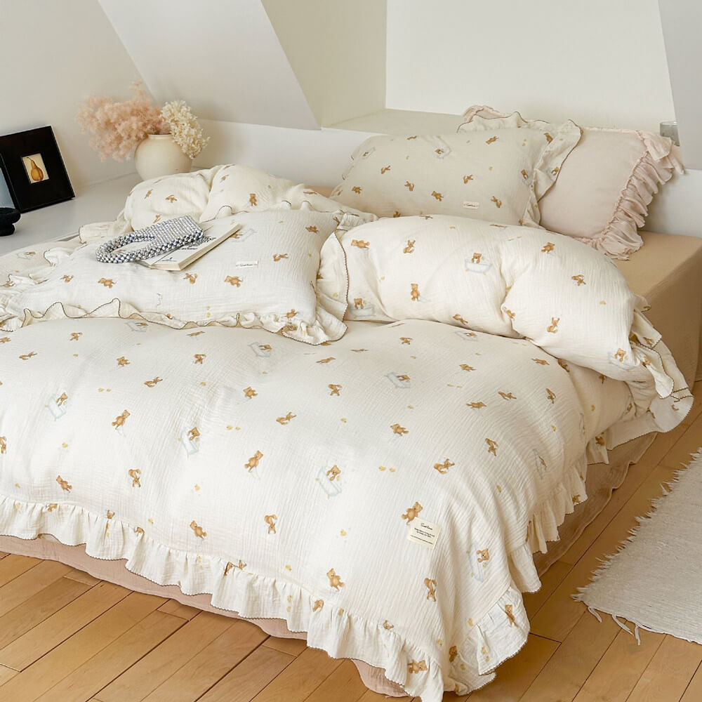 A bed styled with teddy bear bath time duvet cover and khaki flat sheet