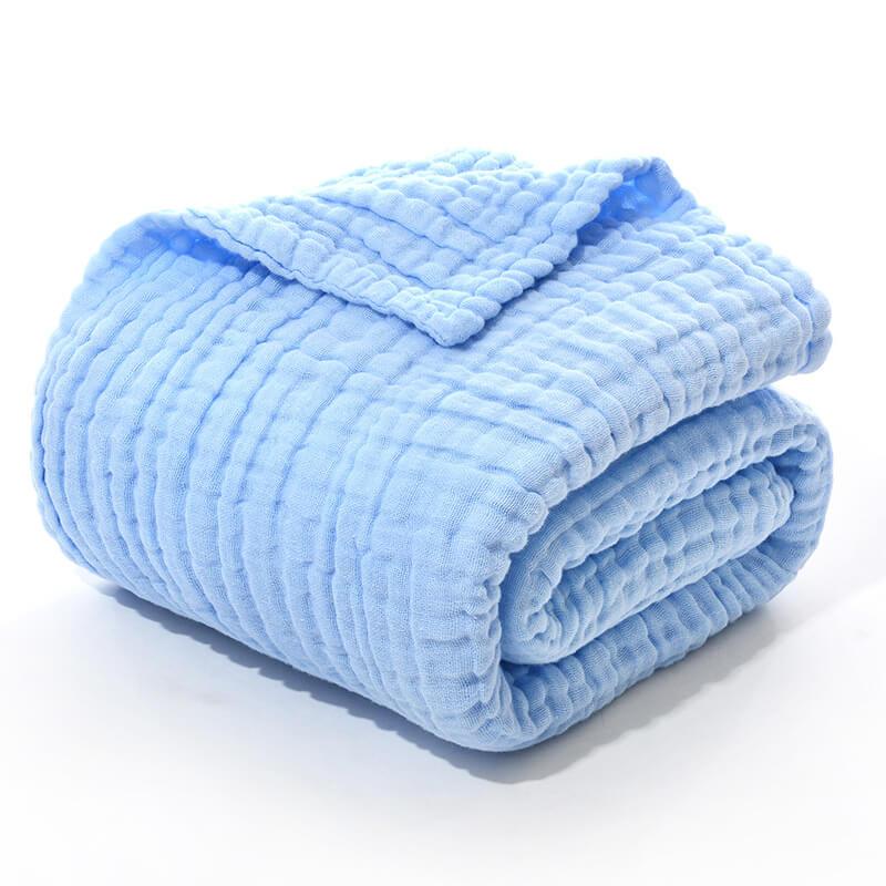 Folded 6-layer cotton muslin newborn swaddle blanket in a solid light blue.