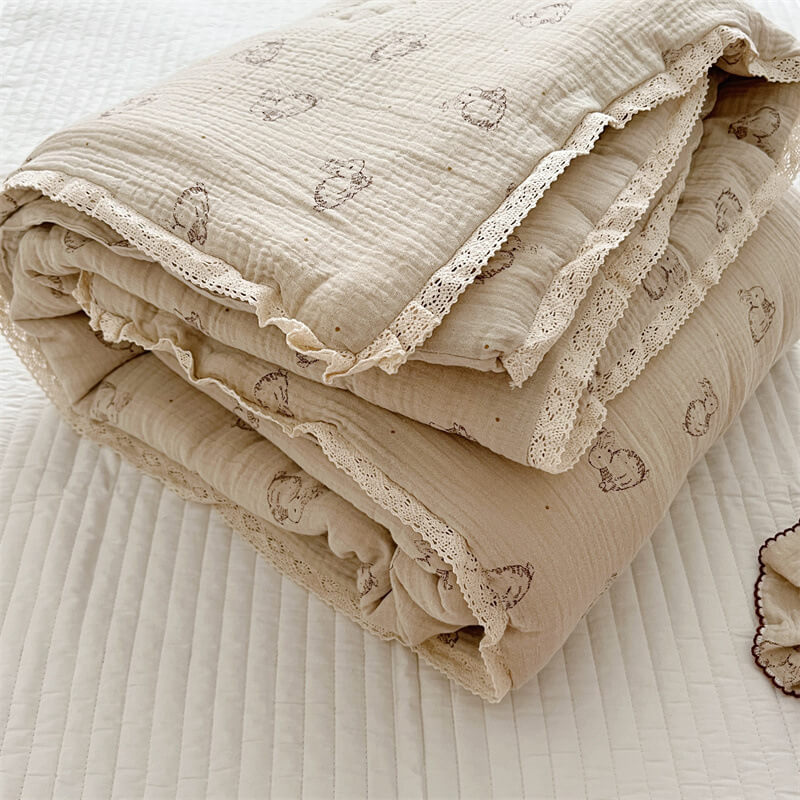 Folded cotton muslin baby comforter with bunny print and cream lace trim