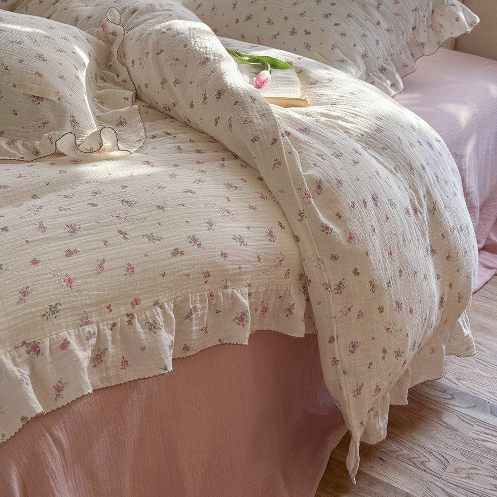 Pink floral bedding with ruffled pillowcase and small lamb print