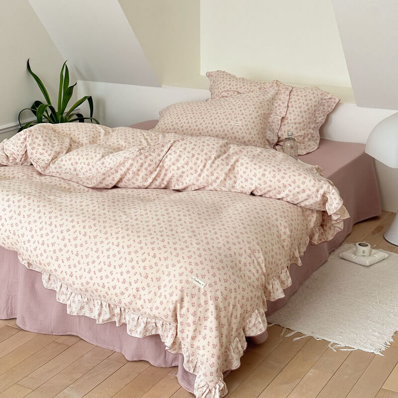 Full view of ditsy pink bedding set in cozy bedroom setting