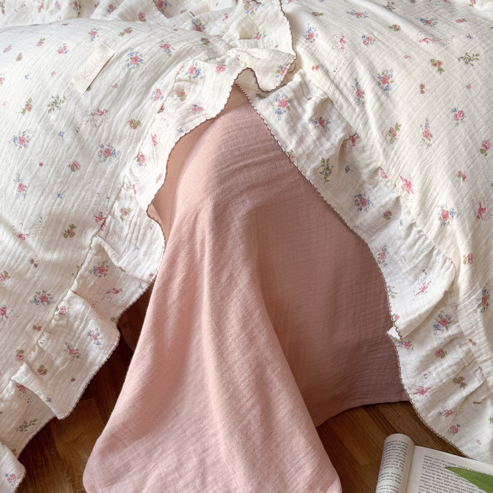 Close-up of pink rose floral cotton gauze duvet cover with ruffles