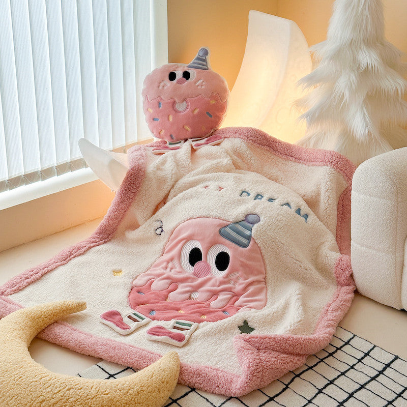 Cozy pink sherpa throw blanket with donut pattern in a child's bedroom