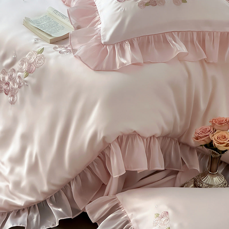 Textured detail of rose embroidery and ruffle edges