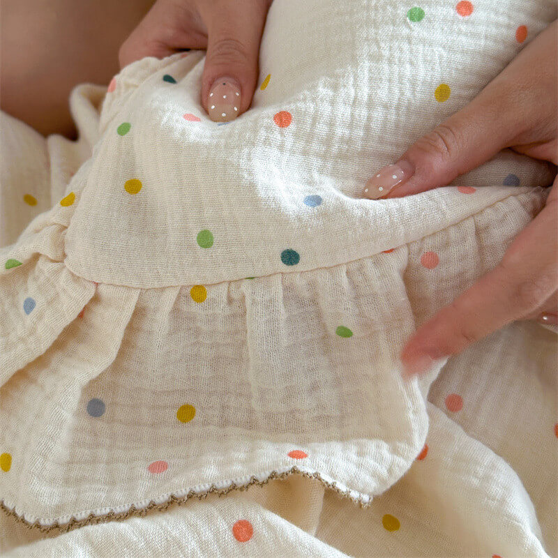 Close-up of ruffle edge polka dot duvet cover and pillowcase in soft muslin