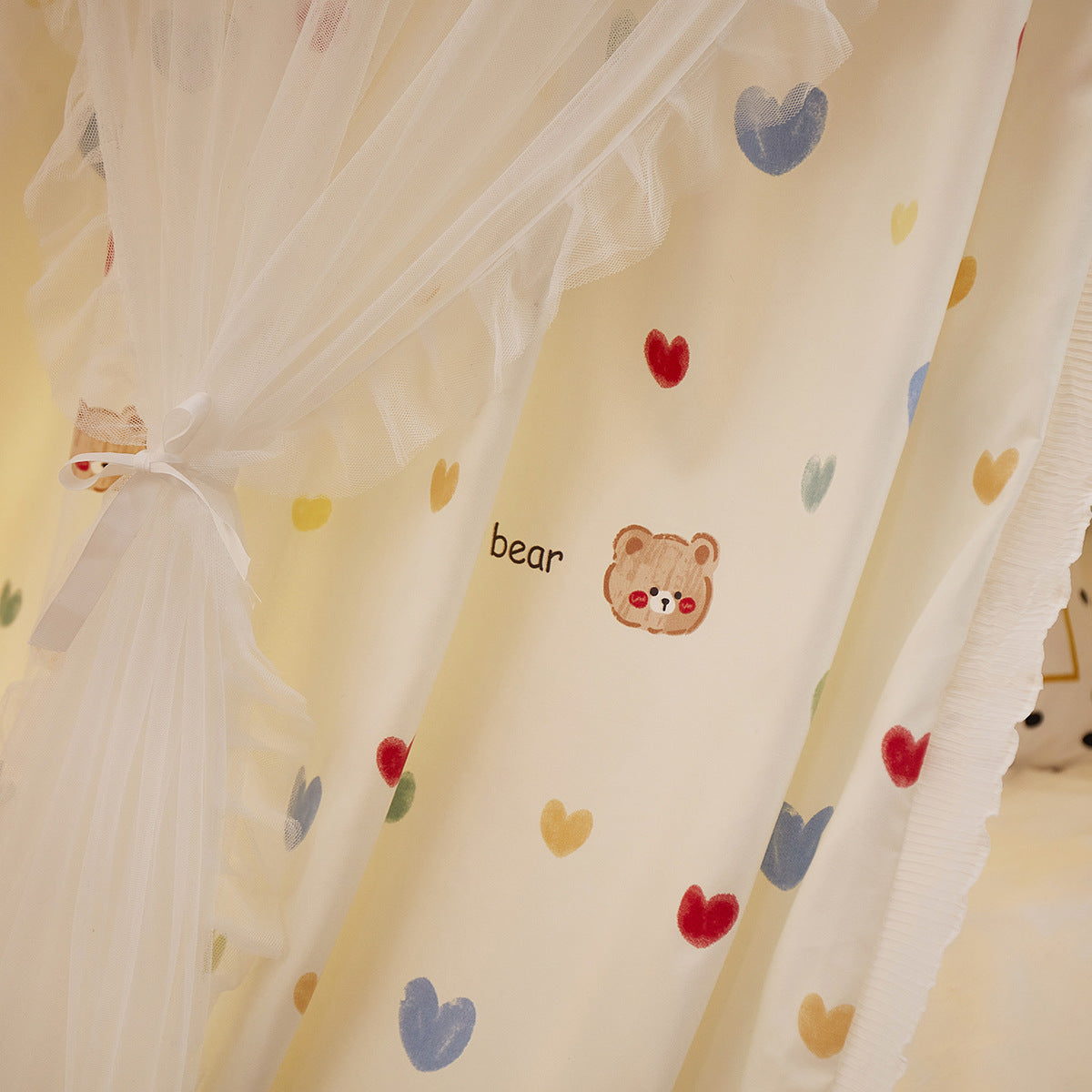 Detailed fabric texture of bear and heart pattern canopy