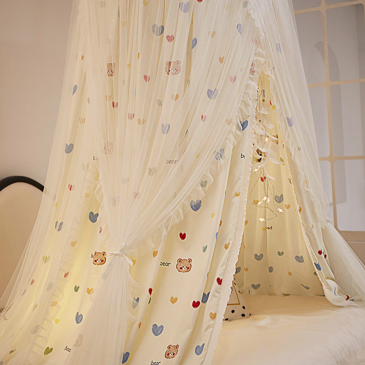 Princess fabric canopy tied to the side with bear heart fabric