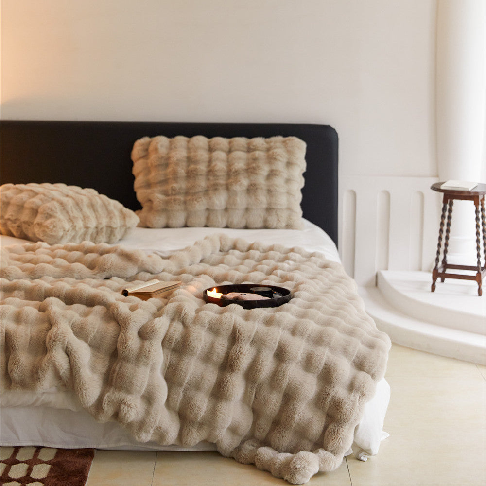 Detailed view of the khaki faux rabbit fur blanket's fluffy material and texture