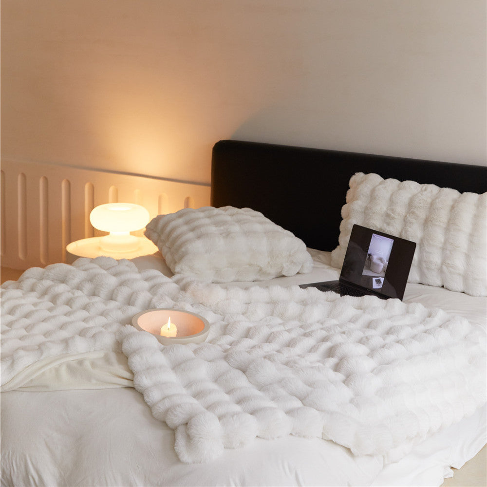 Close-up of the plush, off-white reversible faux rabbit fur throw blanket's texture.