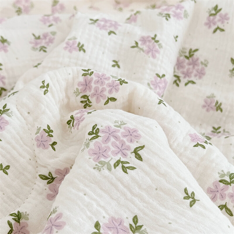 Close-up of lavender flower print on gauze baby quilt