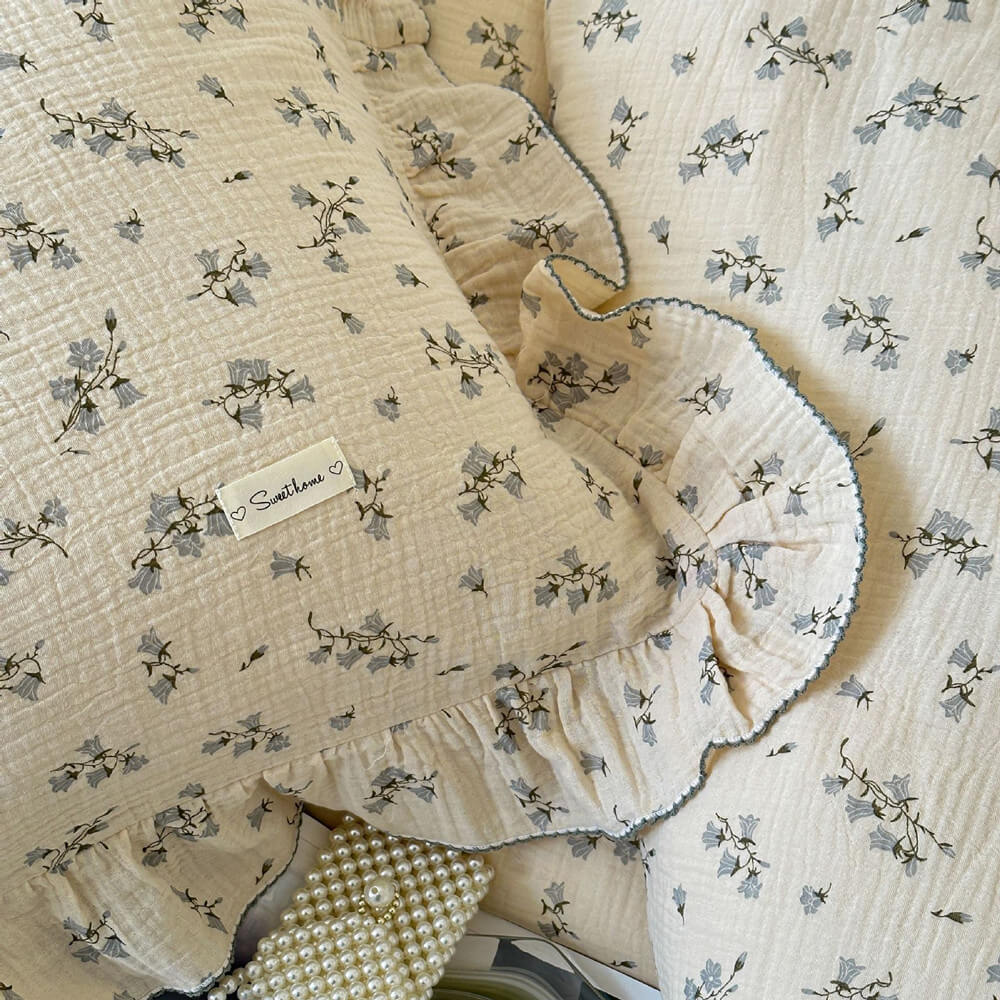 Close-up of ruffled pillowcase in cotton gauze with delicate hyacinth flowers