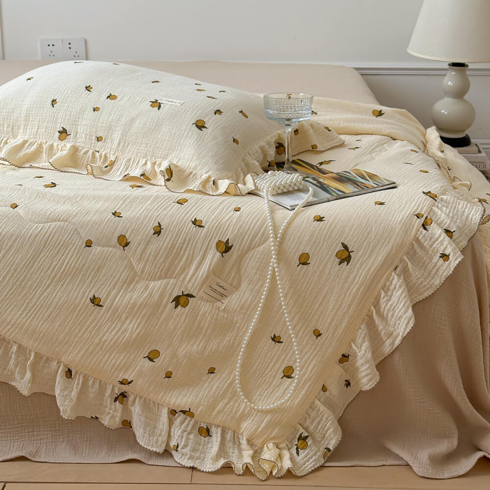 Lemon print muslin quilt with ruffle edge, yellow cotton bedding