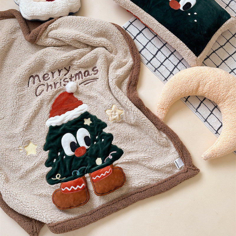 A festive sherpa Christmas blanket with a cartoon Christmas tree design and brown sherpa trim.