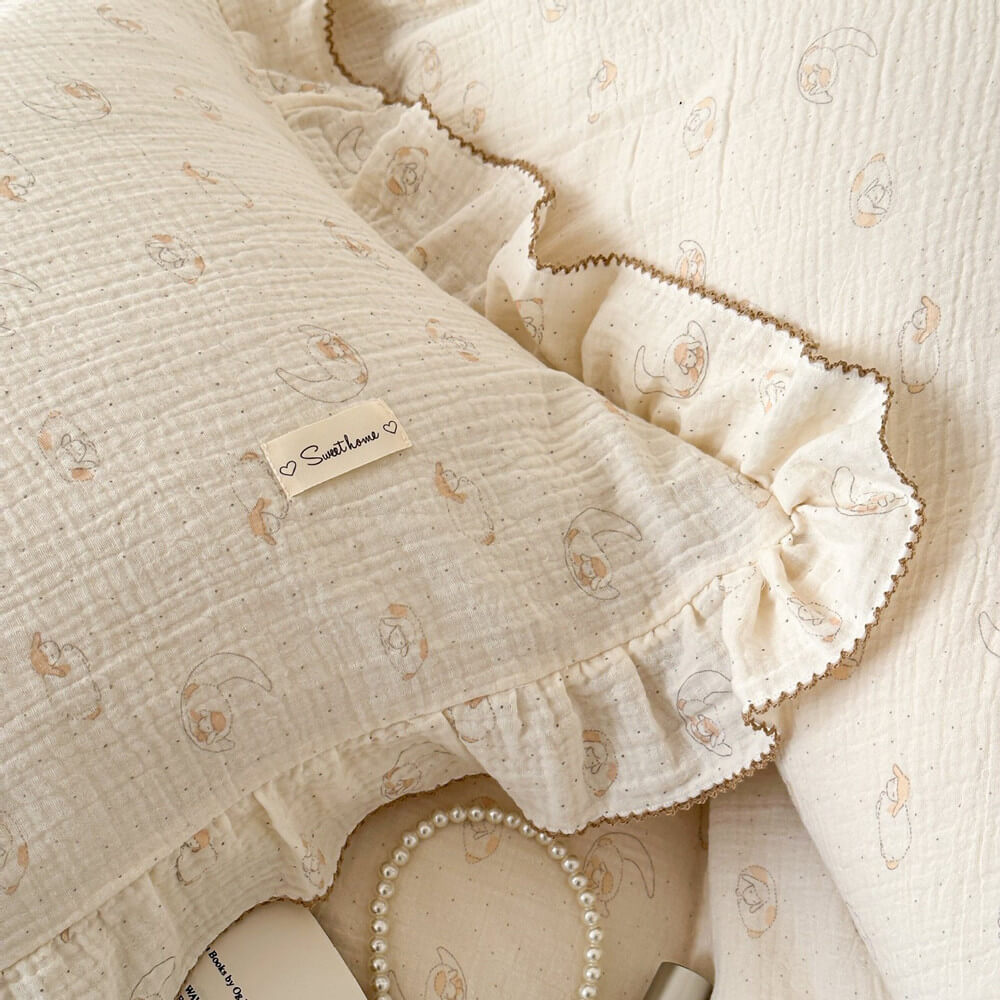 A close-up of a pillowcase from the lamb print duvet set, showing the ruffled trim