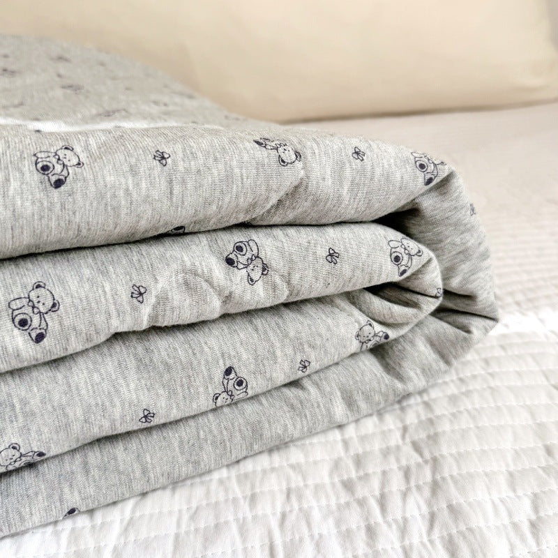 Stacked grey cotton baby comforter with bear print