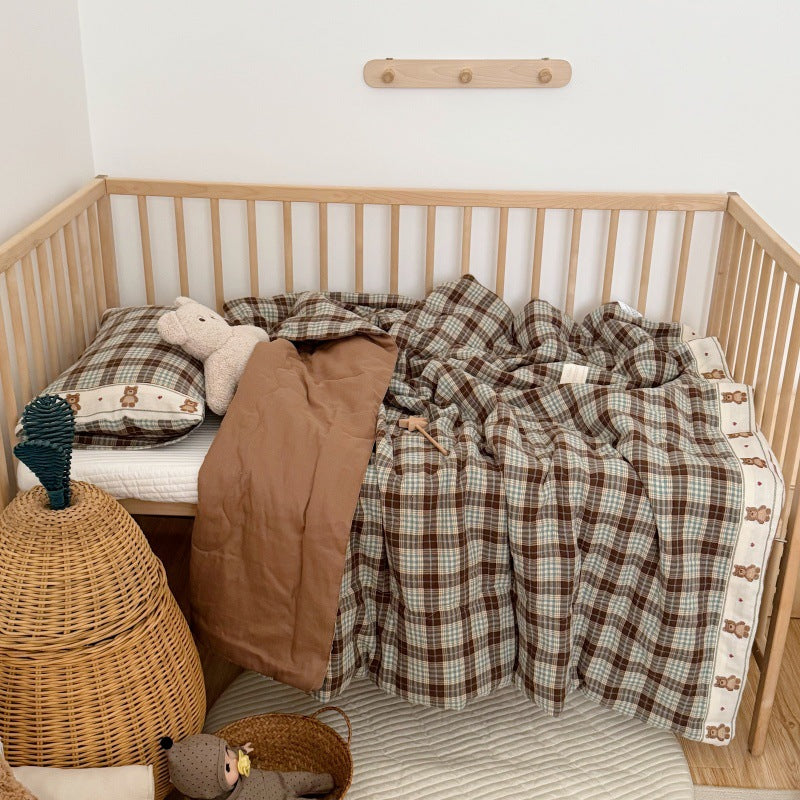 Kids comforter and pillow on bed for a cozy display scene