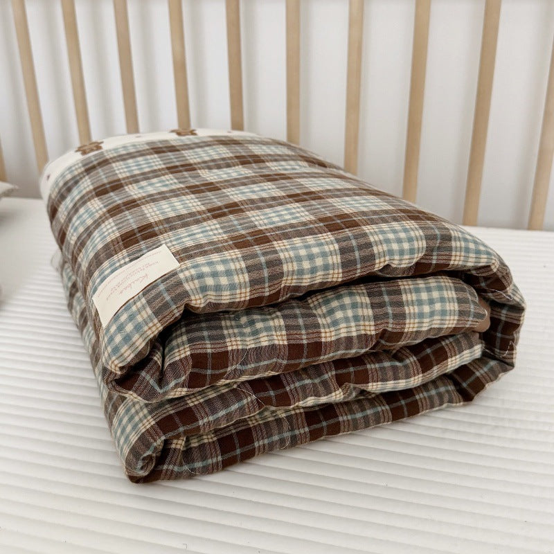 Stacked view of comforter showing thickness, edge stitching, and padded texture