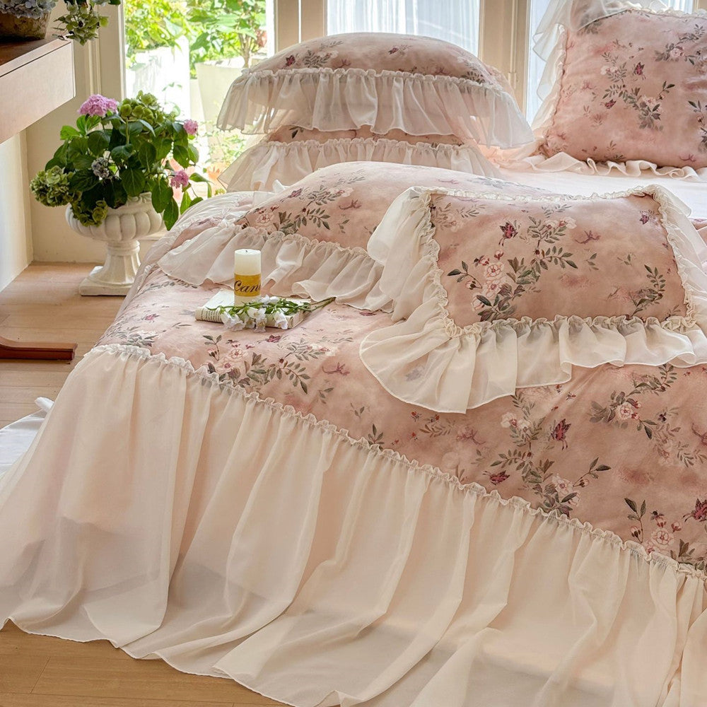 Matching pink pillowcases with ruffled trim and floral design