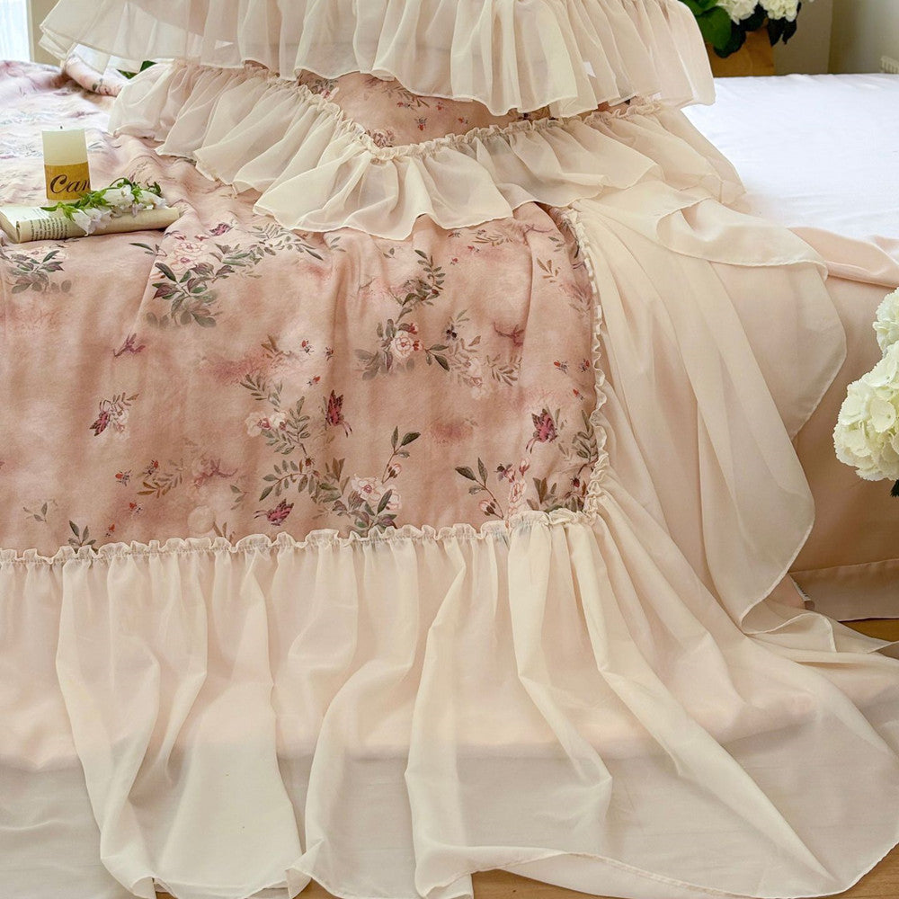 Soft white ruffle trim detail on pink floral comforter