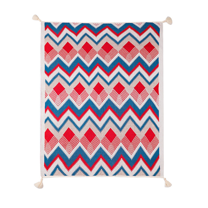 A full, top-down view of a red, white, and blue chevron knitted throw blanket with tassels, laid out flat to showcase the entire pattern and size (130x170 cm) on a white background.