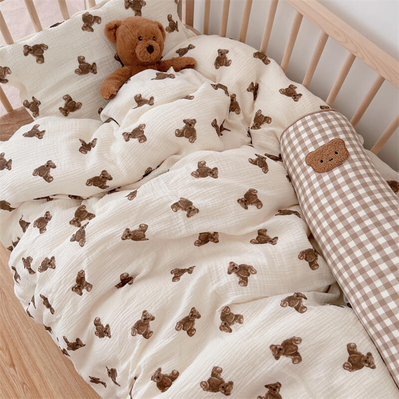 Bear bedding set styled with plush toys in a nursery