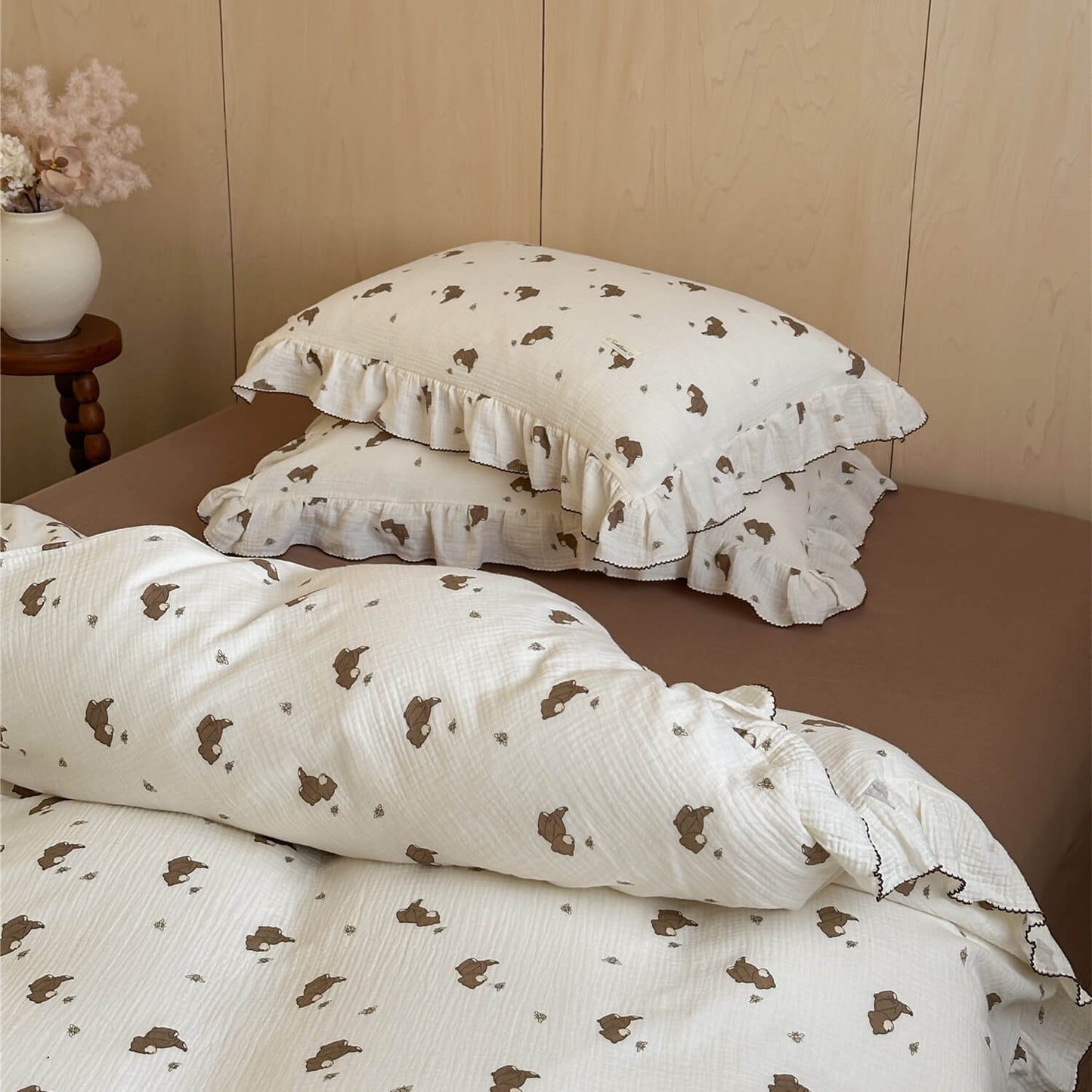 Bear print bedding set and solid brown crinkled cotton flat sheet in sunlight