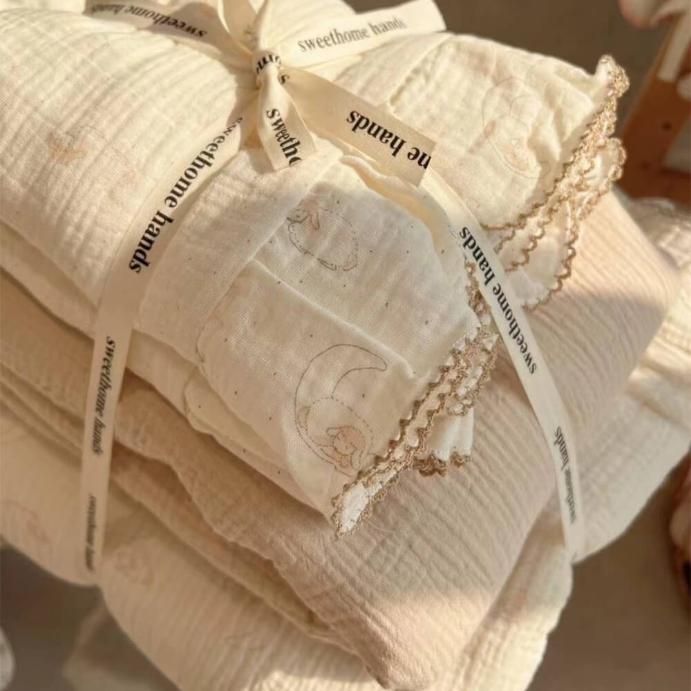 A close-up shot of the folded lamb print duvet set, tied with a ribbon