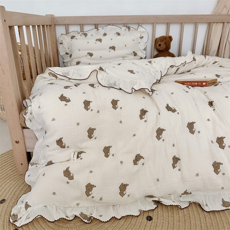 Close-up of ruffled bear print bedding set on a toddler bed